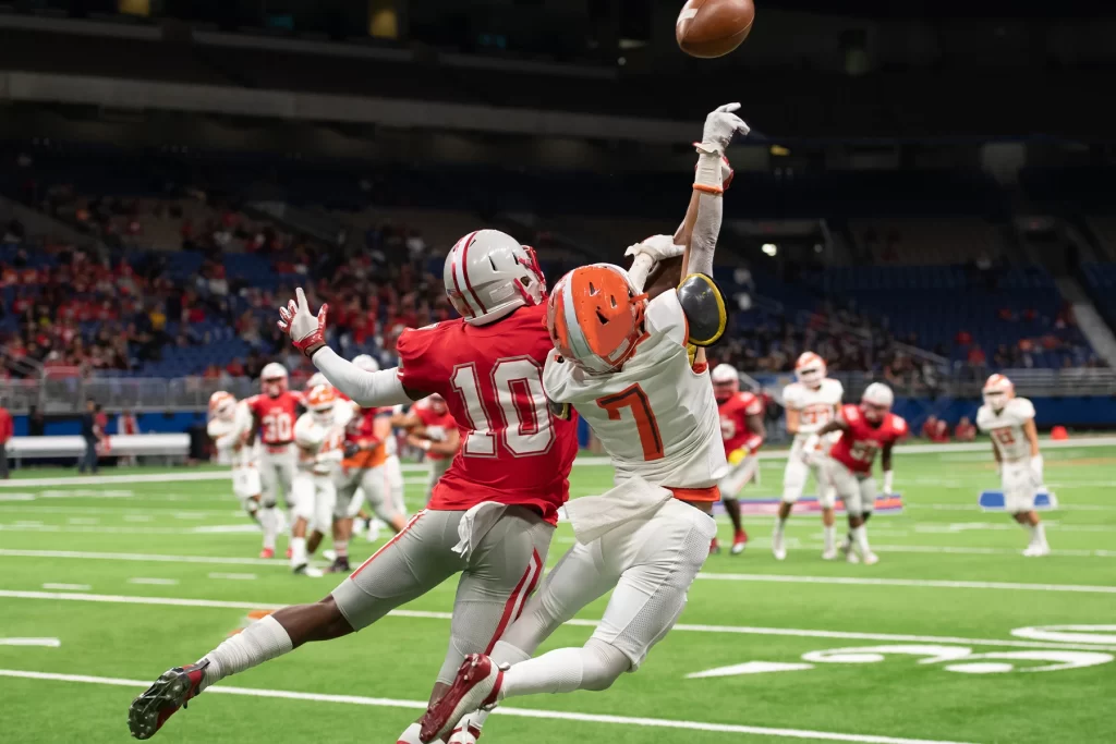 Football players jumping for a ball